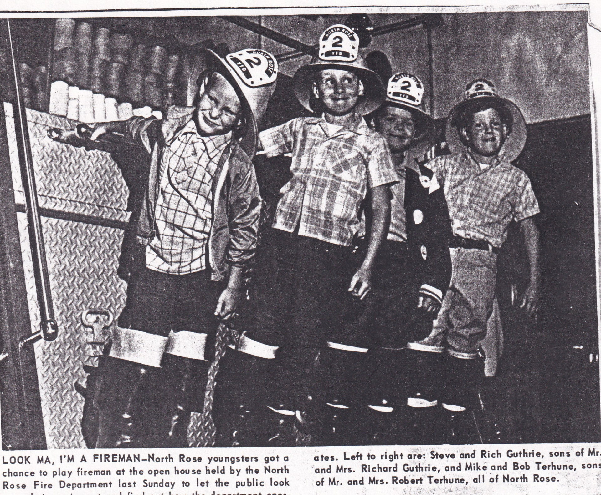 “Look Ma, I'm A Fireman” — North Rose youngsters play fireman at the department's open house: Steve and Rich Guthrie, sons of Mr. and Mrs. Richard Guthrie, and Mike and Bob Terhune, sons of Mr. and Mrs. Robert Terhune