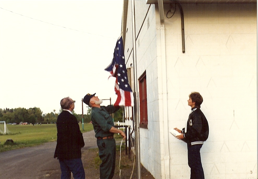 The Ladies Auxiliary presents the American flag at the North Rose Fire Hall
